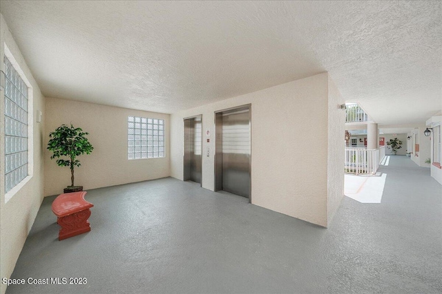 3360 S Atlantic Ave Unit 301, Cocoa Beach, FL 32931 - spare room with a textured ceiling and elevator