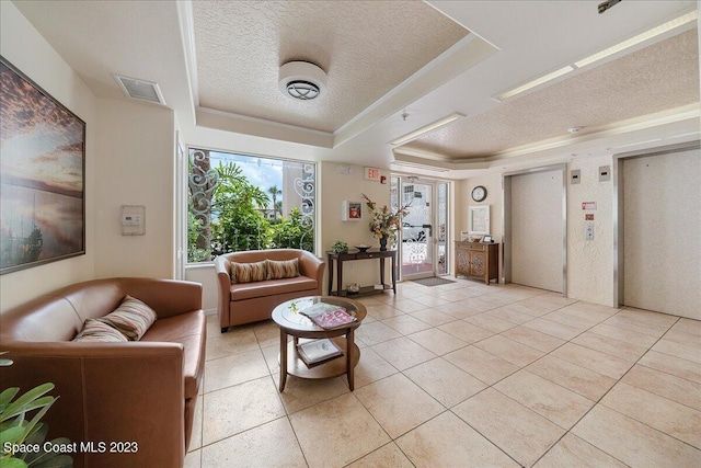 3360 S Atlantic Ave Unit 301, Cocoa Beach, FL 32931 - living room featuring a tray ceiling, a textured ceiling, light tile patterned flooring, and elevator