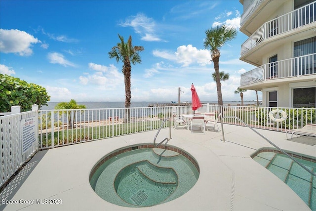 3360 S Atlantic Ave Unit 301, Cocoa Beach, FL 32931 - view of swimming pool featuring a water view, a patio area, and outdoor dining area