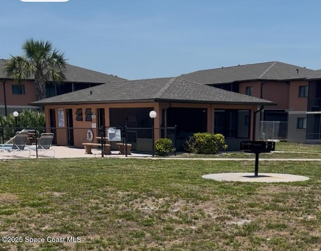 1602 University Ln Unit 1307, Cocoa, FL 32922 - back of house with a patio area and roof with shingles