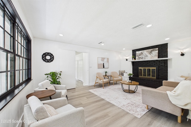 2318 Old Samsula Rd, Port Orange, FL 32128 - living room with light wood-type flooring, a fireplace, recessed lighting, and baseboards