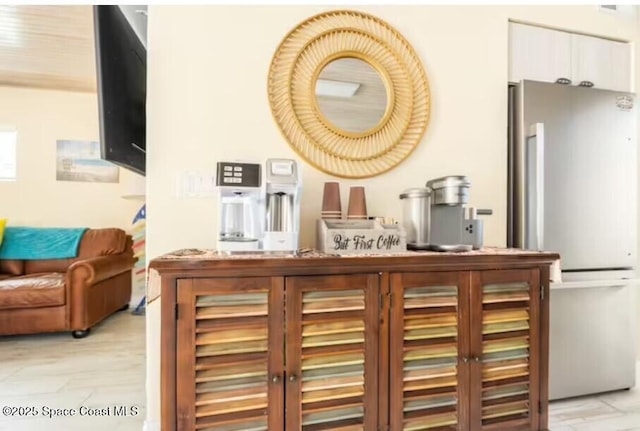 303 Winslow Cir, Cocoa Beach, FL 32931 - bar featuring freestanding refrigerator