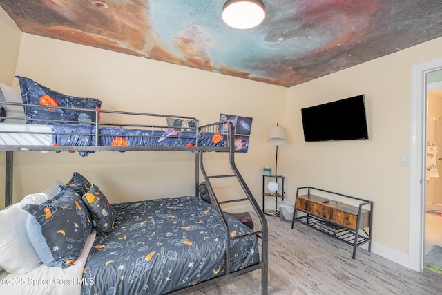 303 Winslow Cir, Cocoa Beach, FL 32931 - bedroom featuring wood finished floors and baseboards