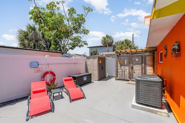 303 Winslow Cir, Cocoa Beach, FL 32931 - fenced backyard with central AC unit and a patio area