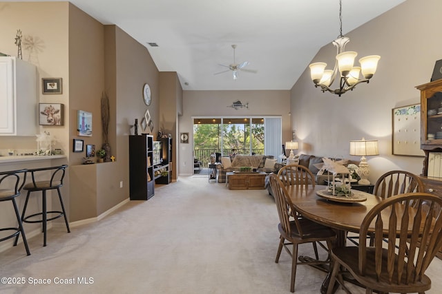 401 Trotter Ln Unit 202, Melbourne, FL 32940 - dining room with ceiling fan, light carpet, high vaulted ceiling, a chandelier, and baseboards