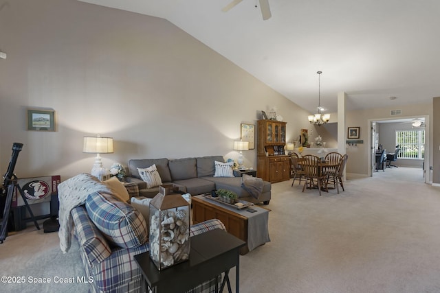 401 Trotter Ln Unit 202, Melbourne, FL 32940 - living area featuring a ceiling fan, vaulted ceiling, light carpet, and a chandelier