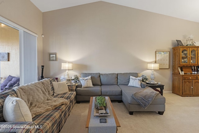 401 Trotter Ln Unit 202, Melbourne, FL 32940 - living room with light carpet and vaulted ceiling