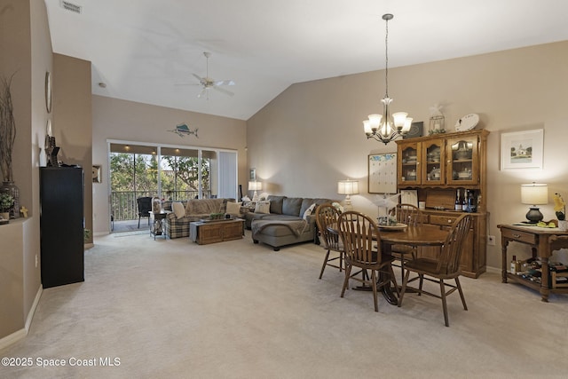 401 Trotter Ln Unit 202, Melbourne, FL 32940 - dining room with light colored carpet, a chandelier, ceiling fan, high vaulted ceiling, and baseboards
