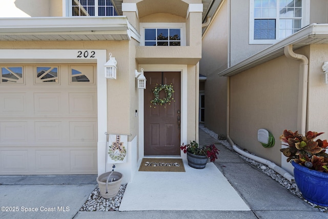 401 Trotter Ln Unit 202, Melbourne, FL 32940 - property entrance with stucco siding and a garage