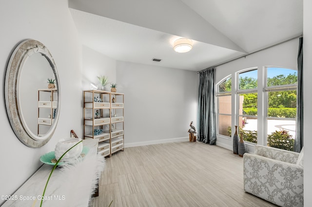 4070 S Tropical Trl, Merritt Island, FL 32952 - living area featuring vaulted ceiling, baseboards, and wood finished floors