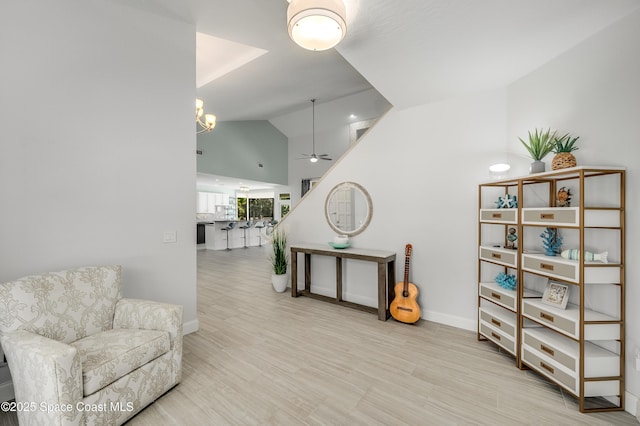 4070 S Tropical Trl, Merritt Island, FL 32952 - living area featuring ceiling fan, baseboards, high vaulted ceiling, wood finished floors, and a chandelier