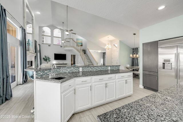 4070 S Tropical Trl, Merritt Island, FL 32952 - kitchen featuring stainless steel built in refrigerator, a sink, ceiling fan, a chandelier, and open floor plan
