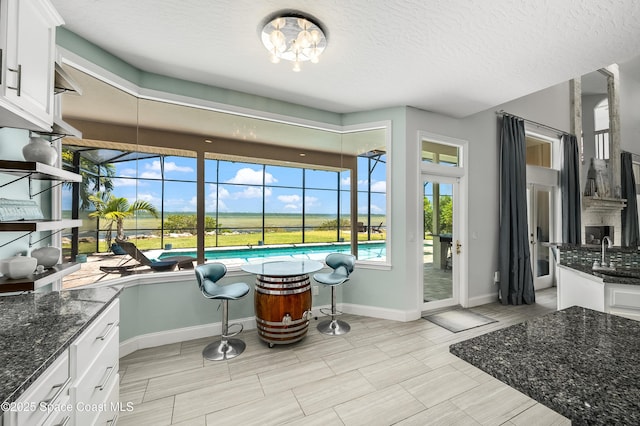 4070 S Tropical Trl, Merritt Island, FL 32952 - dining space featuring baseboards and a textured ceiling
