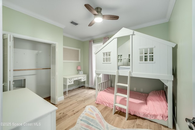 4070 S Tropical Trl, Merritt Island, FL 32952 - bedroom featuring ornamental molding, light wood-style flooring, a ceiling fan, and baseboards