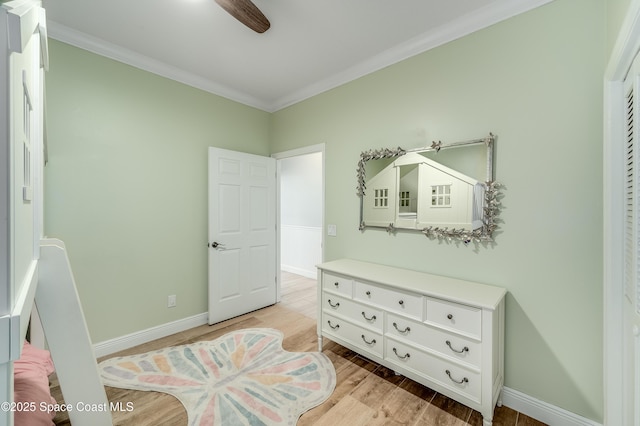 4070 S Tropical Trl, Merritt Island, FL 32952 - bedroom with light wood-style flooring, crown molding, and baseboards