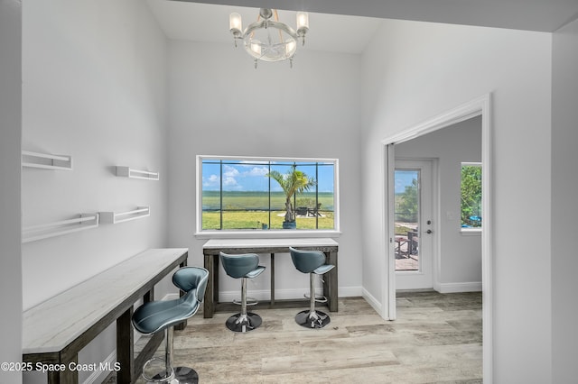 4070 S Tropical Trl, Merritt Island, FL 32952 - office area with wood finished floors, a chandelier, baseboards, and a towering ceiling