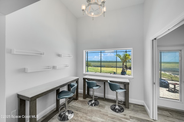 4070 S Tropical Trl, Merritt Island, FL 32952 - office with wood finished floors, a chandelier, baseboards, and a towering ceiling