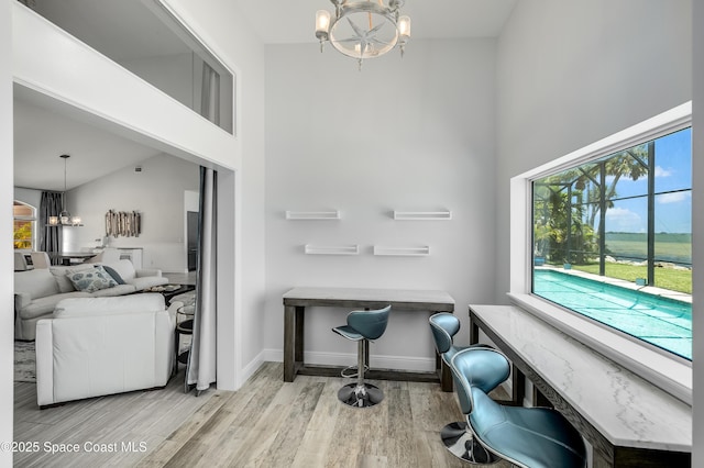 4070 S Tropical Trl, Merritt Island, FL 32952 - office area featuring a chandelier, a towering ceiling, wood finished floors, and baseboards