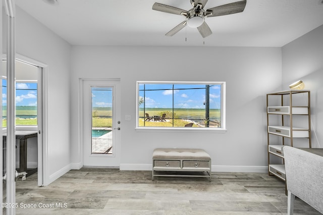 4070 S Tropical Trl, Merritt Island, FL 32952 - entryway with wood finished floors, a ceiling fan, plenty of natural light, and baseboards