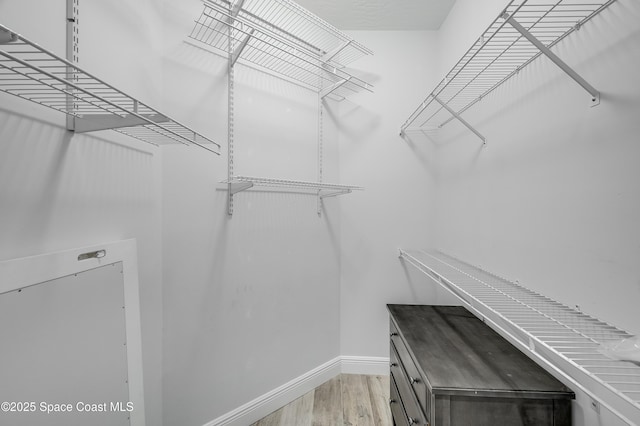 4070 S Tropical Trl, Merritt Island, FL 32952 - spacious closet featuring light wood finished floors