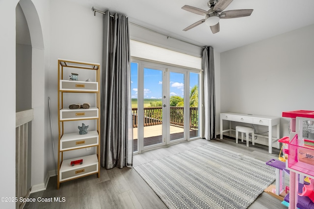 4070 S Tropical Trl, Merritt Island, FL 32952 - game room with arched walkways, ceiling fan, and wood finished floors