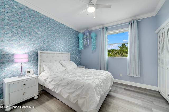4070 S Tropical Trl, Merritt Island, FL 32952 - bedroom with ornamental molding, wood finished floors, baseboards, a closet, and a ceiling fan