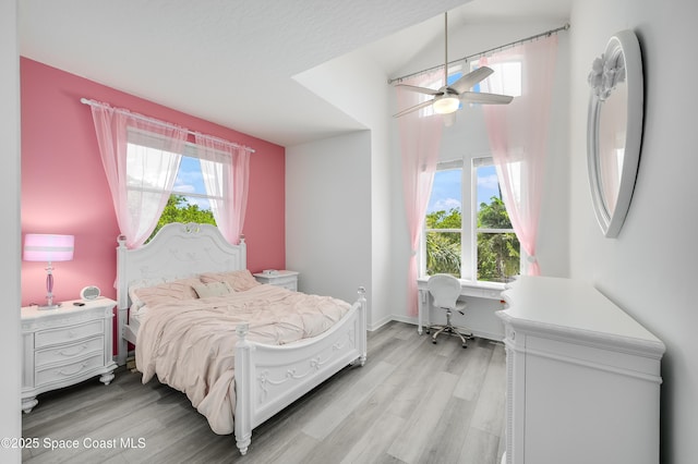 4070 S Tropical Trl, Merritt Island, FL 32952 - bedroom featuring light wood-style floors, multiple windows, and ceiling fan
