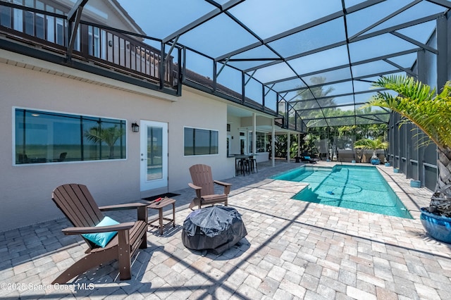 4070 S Tropical Trl, Merritt Island, FL 32952 - swimming pool with a fire pit, a patio, and glass enclosure