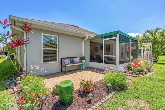 439 Briarcliff Cir, Sebastian, FL 32958 - rear view of property with stucco siding, a sunroom, a patio, and a yard