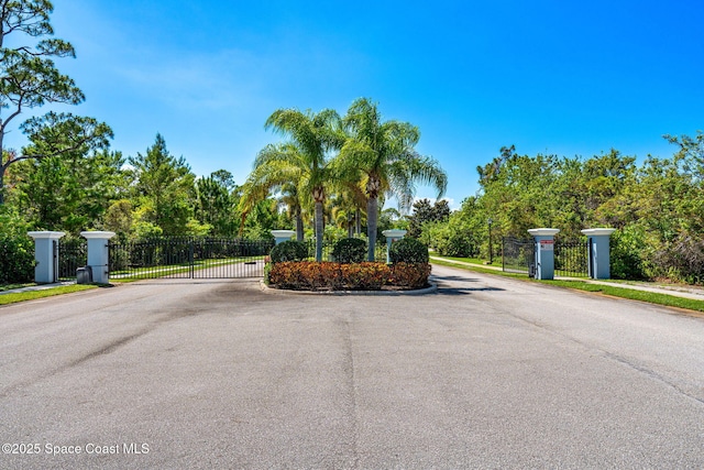 439 Briarcliff Cir, Sebastian, FL 32958 - view of asphalt street with a gate, curbs, a gated entry, and sidewalks