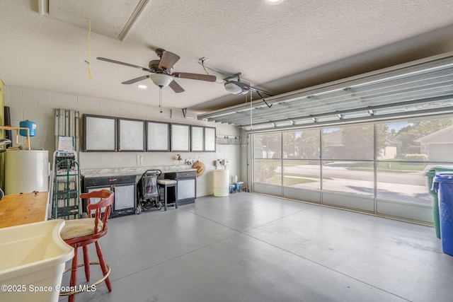439 Briarcliff Cir, Sebastian, FL 32958 - garage with gas water heater, ceiling fan, concrete block wall, and a garage door opener