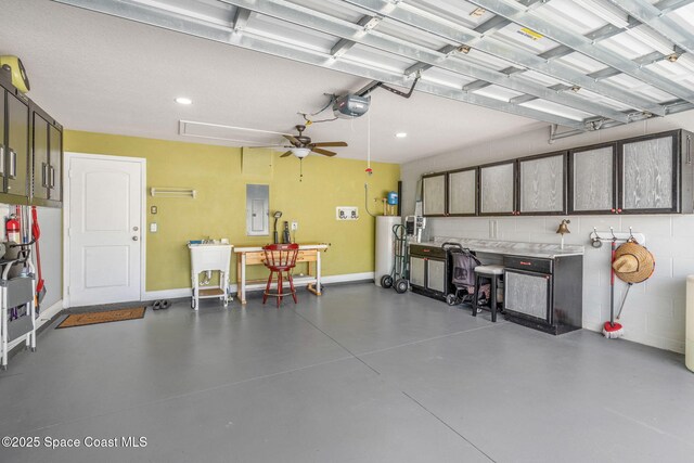 439 Briarcliff Cir, Sebastian, FL 32958 - garage featuring gas water heater, a garage door opener, electric panel, ceiling fan, and recessed lighting