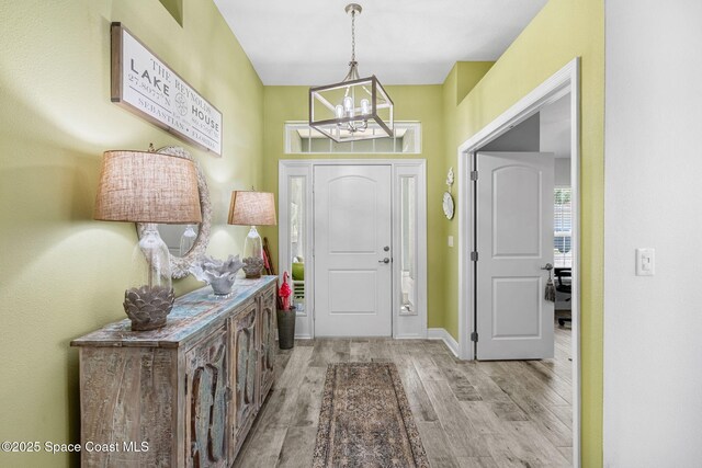 439 Briarcliff Cir, Sebastian, FL 32958 - foyer with a chandelier, wood finished floors, and baseboards