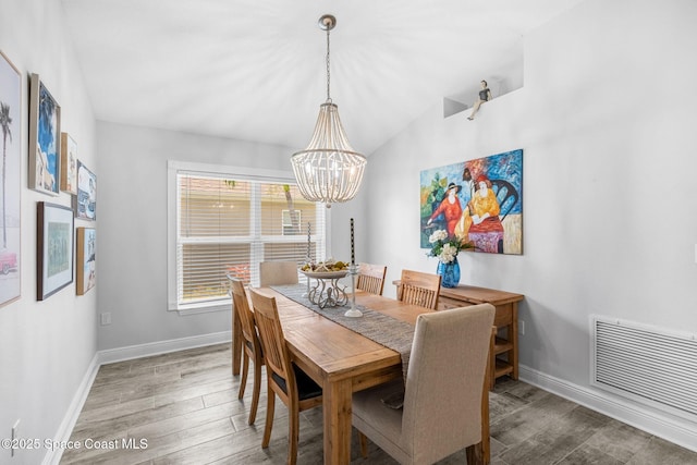 439 Briarcliff Cir, Sebastian, FL 32958 - dining room with a chandelier, baseboards, wood finished floors, and lofted ceiling