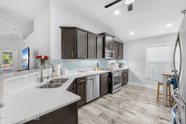 439 Briarcliff Cir, Sebastian, FL 32958 - kitchen featuring appliances with stainless steel finishes, a sink, lofted ceiling, a ceiling fan, and dark brown cabinetry