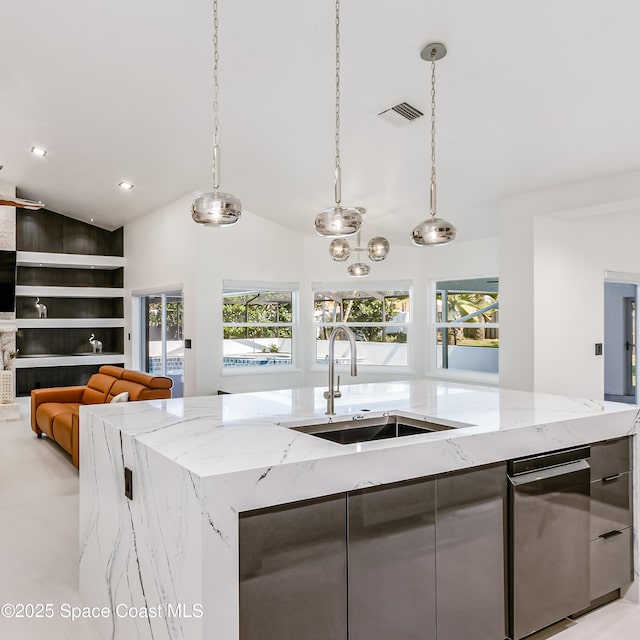 100 Martesia Way, Indian Harbour Beach, FL 32937 - kitchen with a sink, an island with sink, lofted ceiling, decorative light fixtures, and built in features