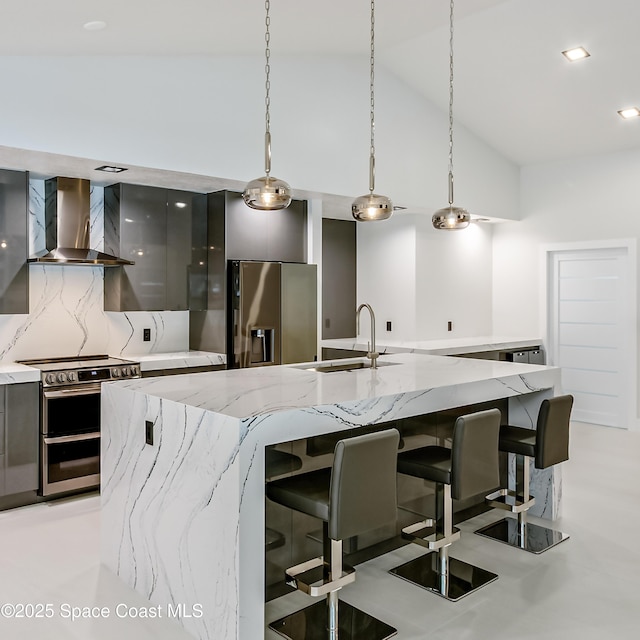 100 Martesia Way, Indian Harbour Beach, FL 32937 - kitchen with wall chimney range hood, appliances with stainless steel finishes, modern cabinets, a sink, and a spacious island