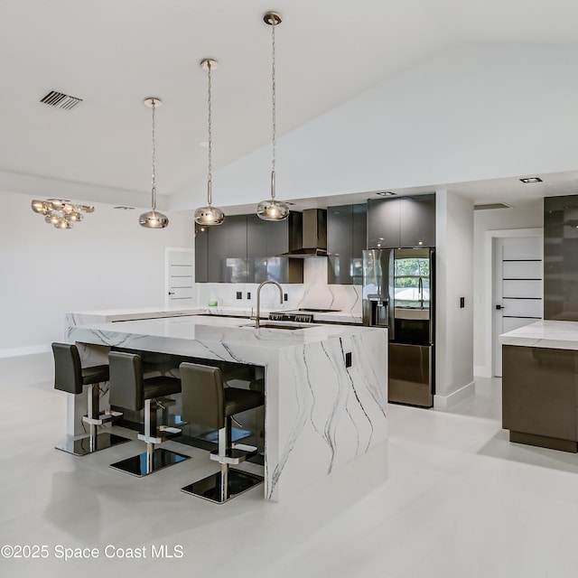 100 Martesia Way, Indian Harbour Beach, FL 32937 - kitchen featuring stainless steel refrigerator with ice dispenser, modern cabinets, lofted ceiling, gray cabinetry, and wall chimney range hood