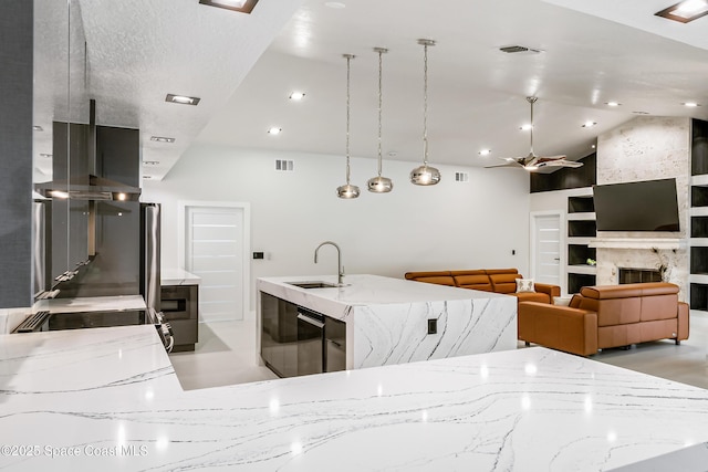 100 Martesia Way, Indian Harbour Beach, FL 32937 - kitchen with a sink, ceiling fan, light stone countertops, lofted ceiling, and built in shelves