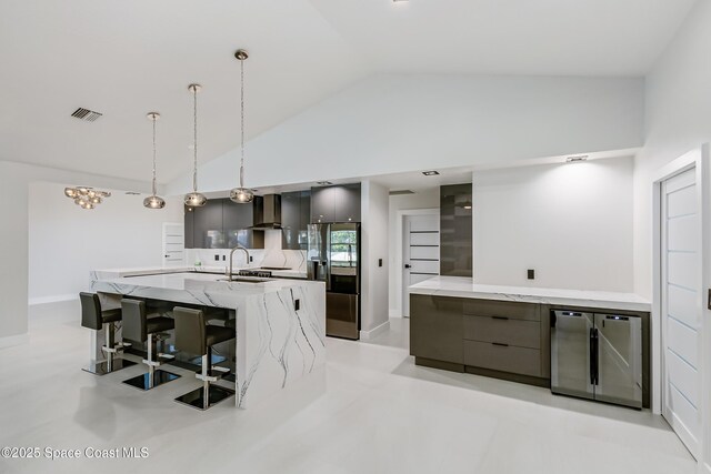 100 Martesia Way, Indian Harbour Beach, FL 32937 - kitchen featuring modern cabinets, stainless steel refrigerator with ice dispenser, fridge, lofted ceiling, and wall chimney exhaust hood