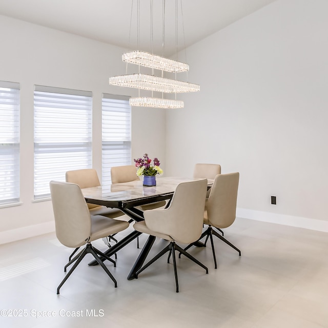 100 Martesia Way, Indian Harbour Beach, FL 32937 - dining area featuring baseboards and a chandelier