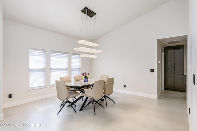 100 Martesia Way, Indian Harbour Beach, FL 32937 - dining area featuring baseboards and a chandelier