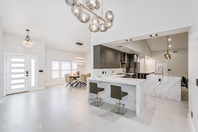 100 Martesia Way, Indian Harbour Beach, FL 32937 - kitchen featuring a chandelier, a sink, modern cabinets, pendant lighting, and high vaulted ceiling