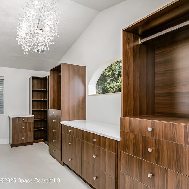 100 Martesia Way, Indian Harbour Beach, FL 32937 - spacious closet featuring lofted ceiling, a chandelier, and light tile patterned flooring