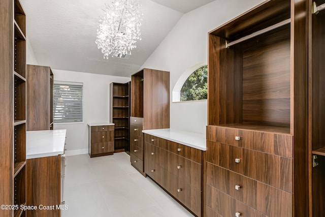100 Martesia Way, Indian Harbour Beach, FL 32937 - spacious closet with a chandelier and vaulted ceiling