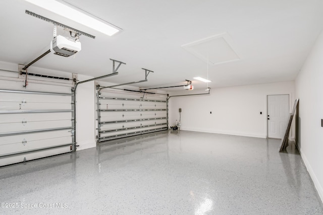 100 Martesia Way, Indian Harbour Beach, FL 32937 - garage featuring baseboards and a garage door opener
