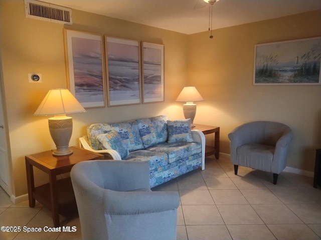 tiled living room featuring baseboards