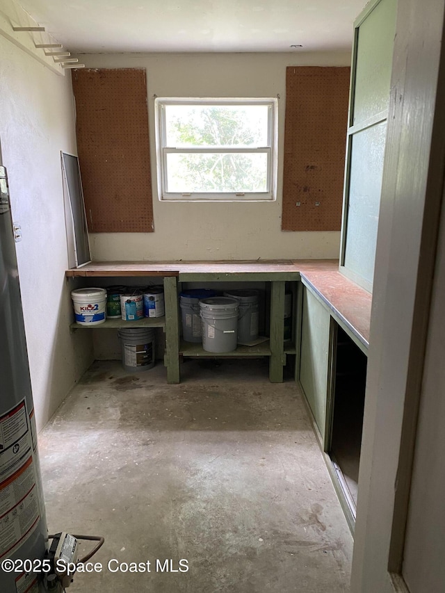 701 Lund Cir, Melbourne, FL 32901 - kitchen with unfinished concrete flooring and gas water heater