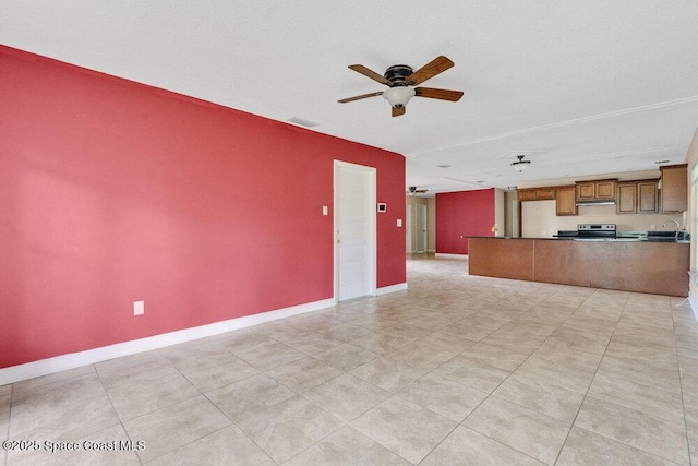 unfurnished living room featuring ceiling fan, light tile patterned floors, and baseboards
