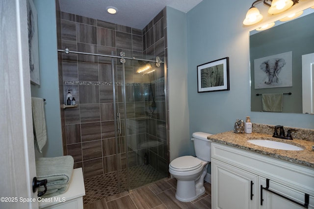 4407 Preservation Cir, Melbourne, FL 32934 - full bathroom featuring a stall shower, vanity, toilet, recessed lighting, and wood tiled floors